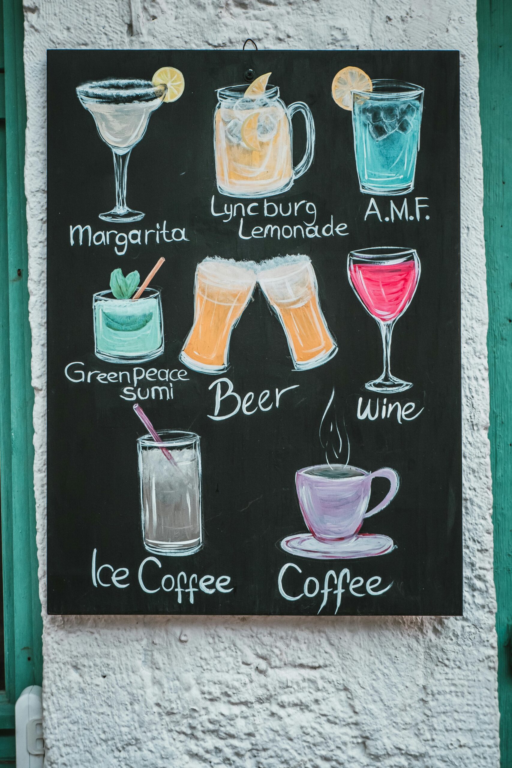 Chalkboard art featuring various colorful drink illustrations and names on a textured wall.